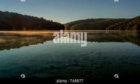 Misty Lakes at dawn within the colorful Plitvice National Park in Croatia Stock Photo