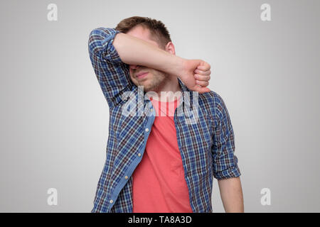 Feeling depressed. Man covering face with hand Stock Photo