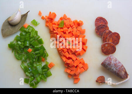 Sliced vegetables on a white kitchen table for the preparation of homemade lentils with vegetables