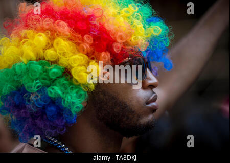NEW YORK CITY - JUNE 25, 2017: A spectator wears an Afro wig in rainbow colors on the sidelines of the annual Pride Parade in Greenwich Village. Stock Photo