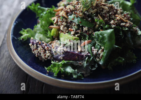 Quinoa salad with vegetable on wooden table Stock Photo