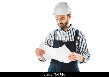 concentrated construction worker in helmet looking at building plan isolated on white Stock Photo