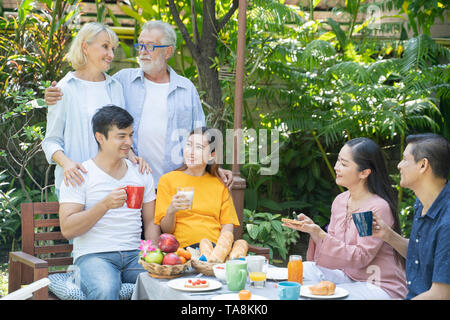 The happiness of two ethnic families - Image Stock Photo