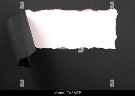 Torn black paper strip white background frame Stock Photo
