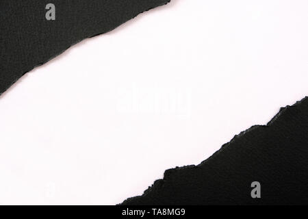 Torn black paper strip diagonal white background Stock Photo