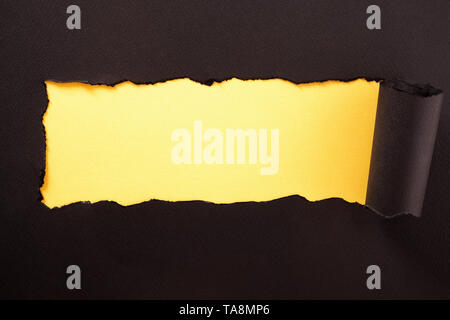 Paper strip torn black yellow background horizontal Stock Photo