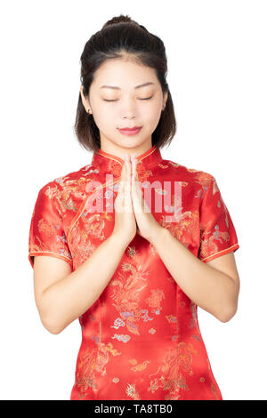 Beautiful Chinese woman wearing a traditional dress known as a Cheongsam or Chipao isolated on a white background Stock Photo