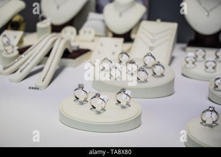 Geneva, Switzerland, March 03, 2019, Gold wedding engagement rings with diamond, brilliant cut on display for sale, gold silver platinum fiancee rings Stock Photo