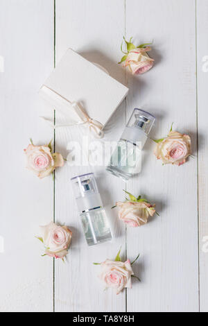 Light spray bottle on a wooden white background Stock Photo