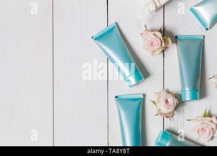 Cosmetics, blue tubes of cream on white wooden background, copyspace Stock Photo