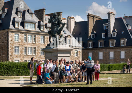 Group of tourists have their picture taken in front of Statue of Jacques Cartier (Breton explorer), Saint Malo, Brittany, France Stock Photo