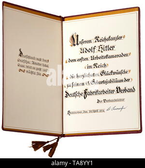 Adolf Hitler - a certificate of honour awarded by the Deutscher Fabrikarbeiter-Verband (DFV) (tr. Factory Workers Union of Germany) Certificate to mark the 45th birthday of the Reichskanzler Adolf Hitler. Double-sided certificate '... dem ersten Arbeitskameraden im Reich...' (tr. '...to the Reich's foremost comrade'), in a leather case with gold print. Designed in several colours, handwritten in Hanover, 20 April 1934 with the original signature of the union head. Dimensions 22 x 30 cm. historic, historical, 20th century, 1930s, NS, National Socialism, Nazism, Third Reich, , Editorial-Use-Only Stock Photo