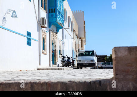 KAIROUAN, TUNISIA, AFRICA-CIRCA MAY, 2012: Tourist buildings and streets are on the center of the city of Kairouan. White and blue facades and paved r Stock Photo