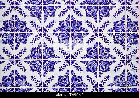 Gorgeous traditional Portuguese ceramic blue tiles with floral pattern. Vintage glazed tiles texture and background. Stock Photo