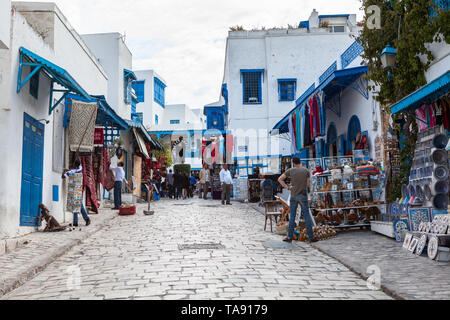 SIDI BOU SAID, TUNISIA, AFRICA-CIRCA MAY, 2012: Sellers with gifts and souvenirs stand on the streets of town in center. Town itself is tourist attrac Stock Photo