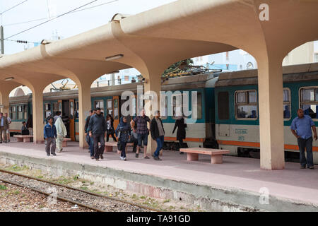 MONASTIR, TUNISIA-CIRCA MAY, 2012: Passengers alight arrived train in Monastir key middle station. The Sahel Metro is an electrified, metre gauge rail Stock Photo
