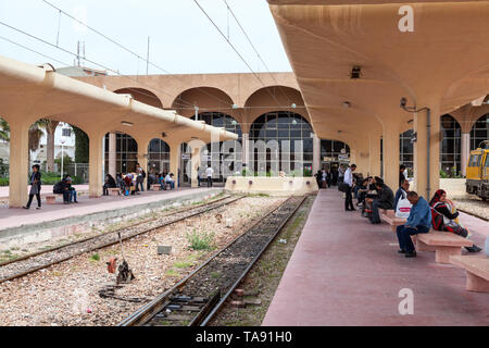 MONASTIR, TUNISIA, AFRICA-CIRCA MAY, 2012: Monastir key middle station with people waiting for train. The Sahel Metro is an electrified, metre gauge r Stock Photo