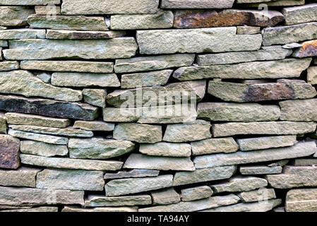 pattern gray color of modern style design decorative uneven cracked real stone wall surface. Stock Photo