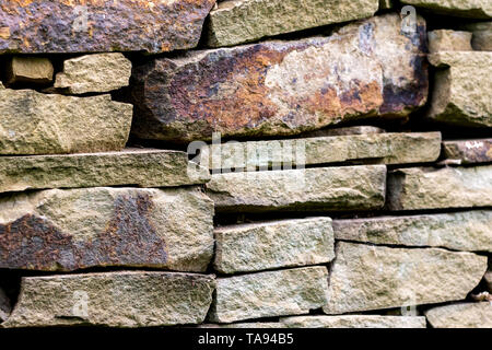 pattern gray color of modern style design decorative uneven cracked real stone wall surface. Stock Photo