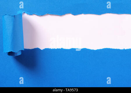 Torn blue paper strip banner white background frame Stock Photo