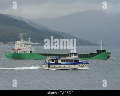 The passenger ferry MV Ali Cat, passes the general cargo vessel Arklow Rose, off Gourock on the Firth of Clyde. Stock Photo