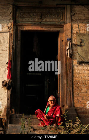 PUNE, MAHARASHTRA, INDIA, February 2019, Old woman sitting front of home. Stock Photo