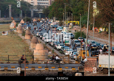 PUNE, MAHARASHTRA, February 2019, Peope walking while vehicles parked on the road. Stock Photo