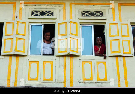 PUNE, MAHARASHTRA, February 2019, Man and old woman looking out from their verandah. Stock Photo