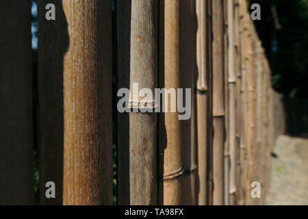 Old brown tone bamboo plank fence for background. Stock Photo