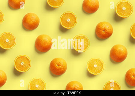 Fruit pattern of fresh orange slices on yellow background. Top view. Copy Space. Pop art design, creative summer concept Stock Photo