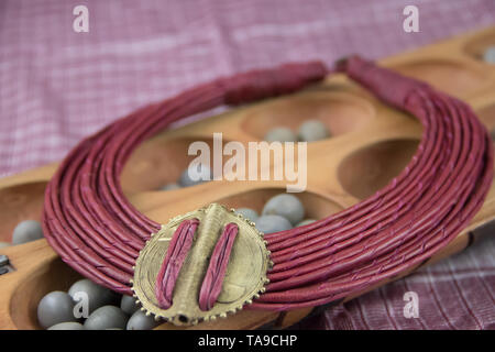 African tribal necklace with background made of African artifacts, private collection Stock Photo