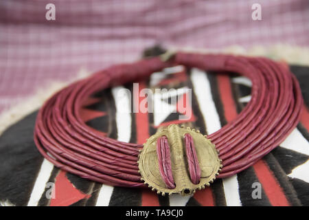 African tribal necklace with background made of African artifacts, private collection Stock Photo