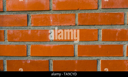 pattern of a Modern wall made of cement and orange bricks, Construction industry background Stock Photo
