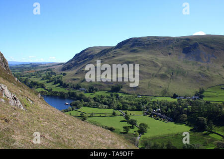 View northeast from slopes of Hallin Fell across Howtown, with steamer at pier, towards Bonscale Pike and Arthur's Pike in English Lake District. Stock Photo