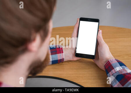 Mockup image - man holding black smartphone with white blank screen Stock Photo