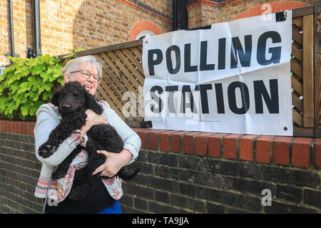 Wimbledon London, UK. 23rd May, 2019. A woman walks her dog to the polling station in Wimbledon to vote at the European Parliament Elections. It is forecast the Brexit Party of Nigel Farage is expected to do well at the expense of Labour and Conservative Parties at Elections which were not suppose to happen if Britain had left the European Union on 29 March  Credit: amer ghazzal/Alamy Live News