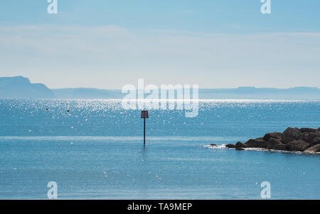 Lyme Regis, Dorset, UK. 23rd May 2019. UK Weather: A glorious morning at the picturesque beach at the seaside town of Lyme Regis. A beach marker on the beach at Lyme Regis against a backdrop of sparkling blue sea and the stunning Jurassic Coastline Credit: Celia McMahon/Alamy Live News. Stock Photo