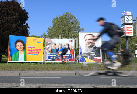 30 April 2019, Hessen, Frankfurt/Main: Cyclists in the east of Frankfurt pass election posters of the FDP (l-r), SPD and CDU for the European elections. The direct election to the European Parliament will take place in Germany on 26 May 2019. 4.7 million Hesse are called to vote. Photo: Arne Dedert/dpa Stock Photo