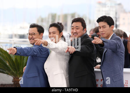 Cannes, France. 23rd May, 2019. (L to R) Director Lee Won-tae, actors Kim Sung-Kyu, Ma Dong-Seok and Kim Moo-Yul pose during a photocall for 'The Gangster, The Cop, The Devil' at the at the 72nd Cannes Film Festival in Cannes, France, May 23, 2019. Credit: Gao Jing/Xinhua/Alamy Live News Stock Photo