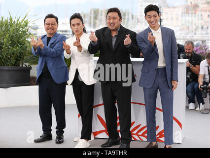 Cannes, France. 23rd May, 2019. (L to R) Director Lee Won-tae, actors Kim Sung-Kyu, Ma Dong-Seok and Kim Moo-Yul pose during a photocall for 'The Gangster, The Cop, The Devil' at the 72nd Cannes Film Festival in Cannes, France, May 23, 2019. Credit: Gao Jing/Xinhua/Alamy Live News Stock Photo