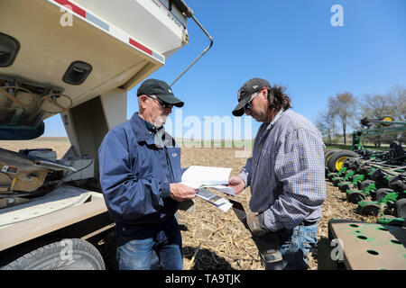 (190523) -- IOWA, May 23, 2019 (Xinhua) -- Bill Pellett and his son Bret checks the purchase record of corn seeds before planting at their family farm in Atlantic of Cass county, Iowa, the United States, April 24, 2019. Bill Pellett knows how to farm, but just like most of his peers across the country, the 71-year-old farmer is feeling less assured of what he could get from a new year of farming, as there appears to be no quick resolution of the year-long trade disputes between the United States and China.   TO GO WITH 'Spotlight: Leading U.S. farming state enters new crop season amid uncertai Stock Photo