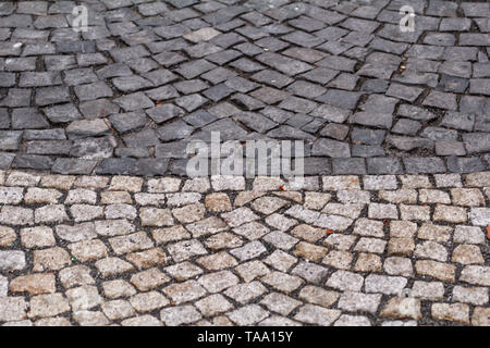 Cobblestones, pavement. Stone pavement texture. Granite patterned cobblestoned pavement floor background. Abstract background of old  pavement. Stock Photo