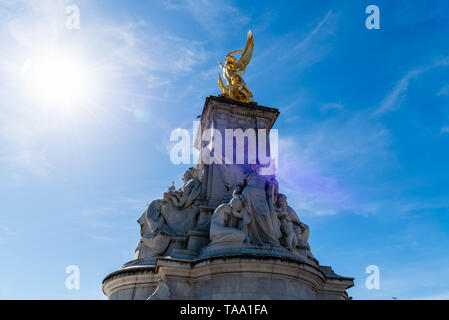 London, UK - May 14, 2019:  Victoria Memorial Sculpture in front of Buckingham Palace a sunny day against blue sky