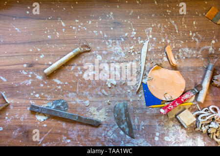 Creative mess on the wooden desk in pottery workshop Stock Photo