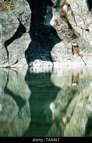 Hard Rock Reflected in Still Water, Gokyo Lake, Nepal, Asia Stock Photo