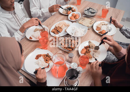 top view of hand eating in dinner table together with family Stock Photo