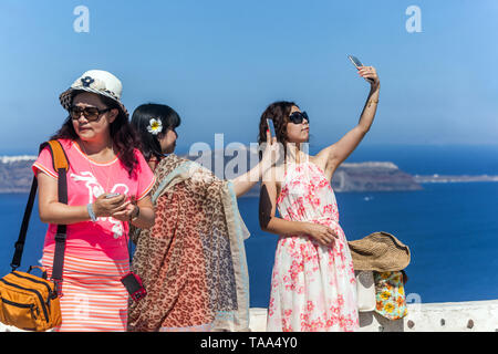 Greece Santorini, People, Tourists, Young Asian women taking a photo on phone, Europe, people on holiday Stock Photo