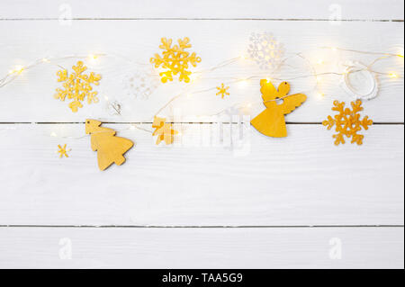 Christmas background for greeting card with place for text. x-mas golden toys and ribbon on wooden background. Flat lay, top view photo mockup Stock Photo