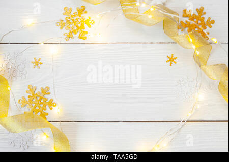 Christmas background for greeting card with place for text. x-mas golden toys and ribbon on wooden background. Flat lay, top view photo mockup Stock Photo