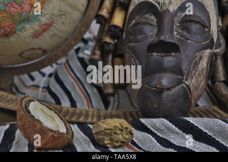 Retro globe with African artifacts and Tribal mask from Uganda Stock Photo